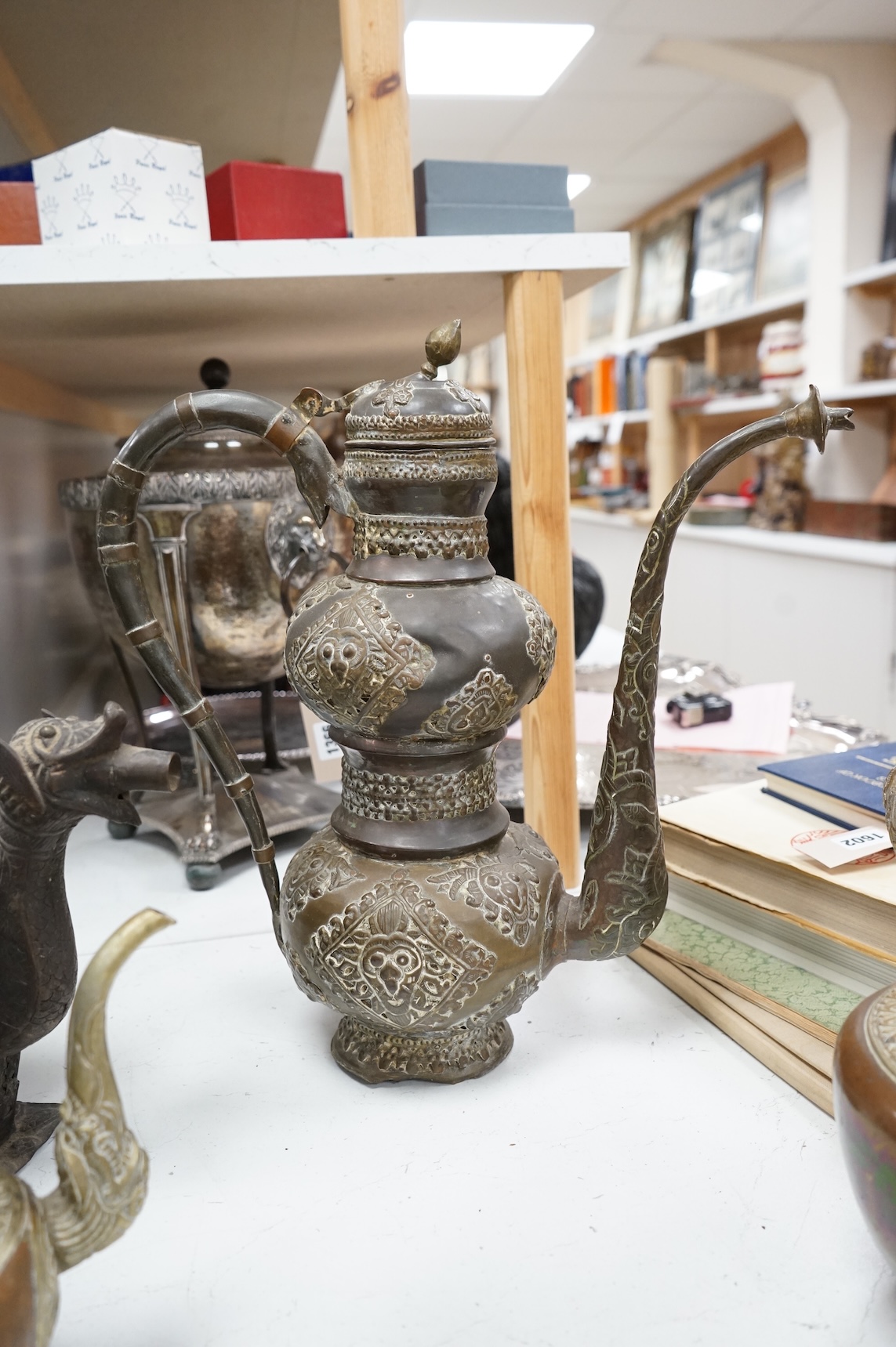A collection of Asian embossed metalware, largest 41cm high